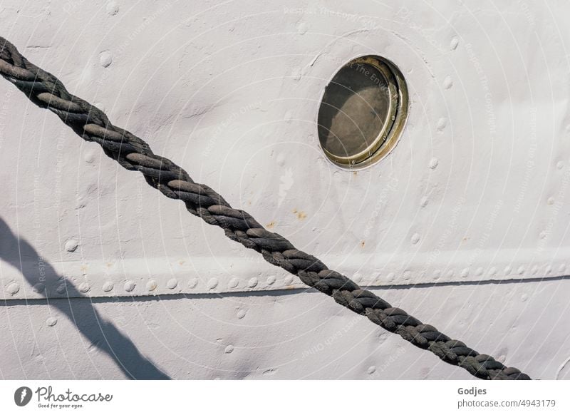 Ship front with porthole and rope ship Porthole Steel Rope Navigation Maritime Exterior shot Colour photo Deserted White Harbour Watercraft Close-up Day boat