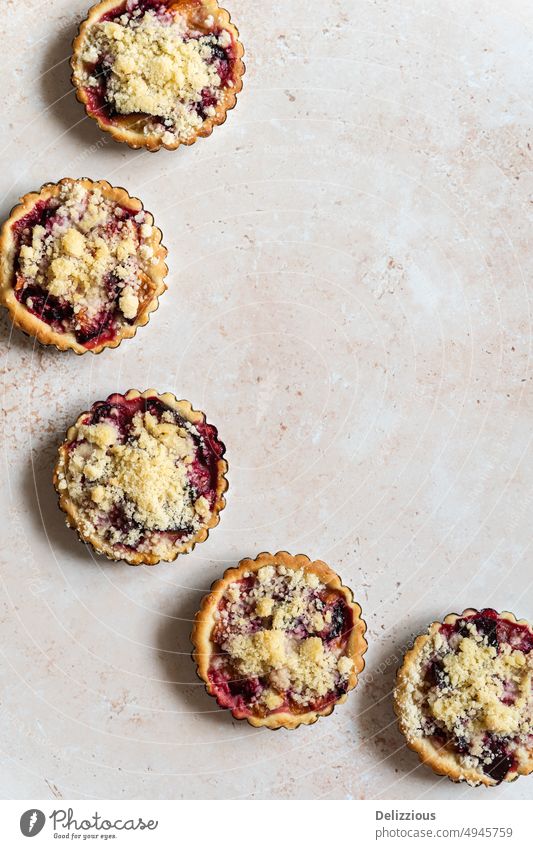 Five home baked plum crumble tarts from above pie fresh food background no people ingredient several fruit pies dough fruitcake treat sticky snack homemade