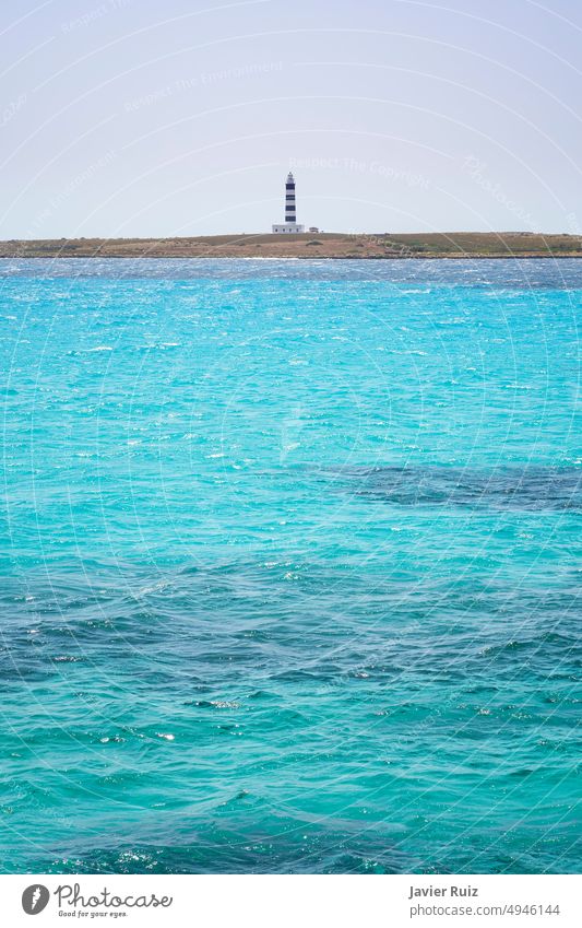 in flat Photocase Royalty blacco, vertical, Photo the - Free copy space sea A a background a lighthouse Stock and waves, with blue the some to foreground from in turquoise