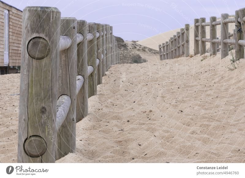 Rough wooden fences for connecting bicycles in dune on the beach. Beach Ocean coast Sand Summer Relaxation Tourism duene Landscape dunes Vacation & Travel off