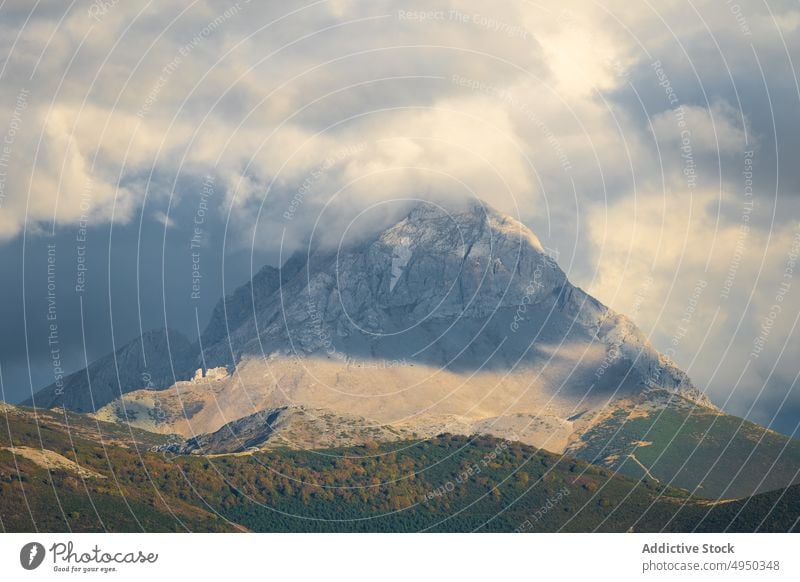 Snowy mountain against cloudy sky peak ridge snow daytime landscape highland slope picos de europa spain rock scenic geology scenery weather nature countryside