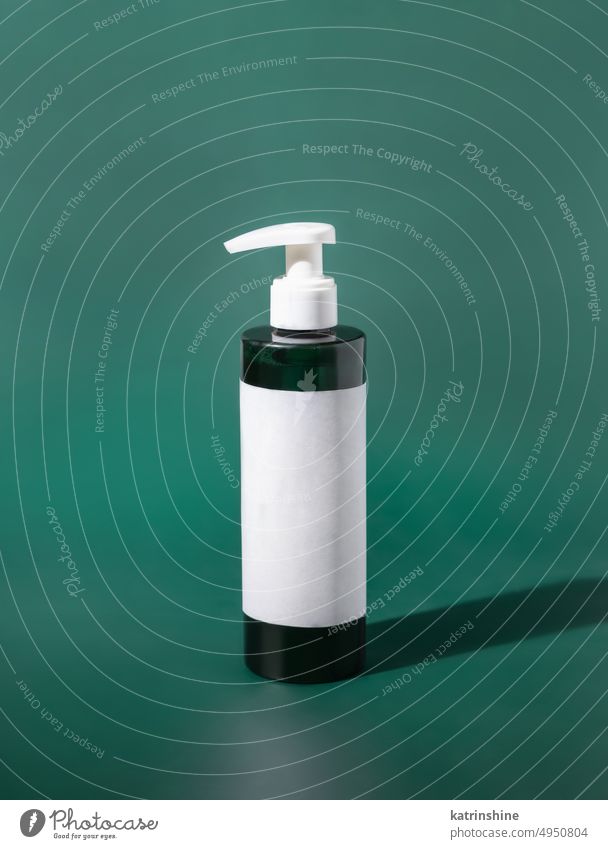 One pump Plastic bottle with blank label on green. Cosmetic packaging Mockup one pump mockup white negative space copy space close up Brand plastic natural