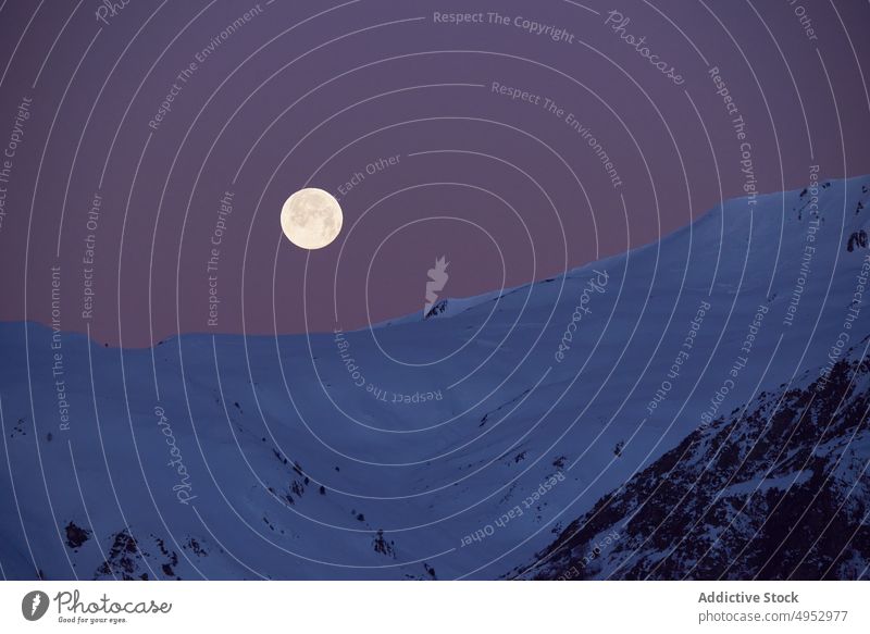 Moon over snowy mountains at night moon landscape range winter scenery wildlife nature frost ridge cold peak frozen full glow slope summit rock geology