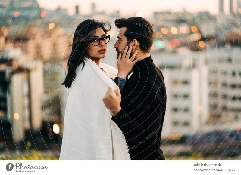 Ethnic couple embracing in city in evening embrace love relationship soulmate idyllic plaid portrait romantic fondness enjoy ethnic girlfriend boyfriend amour