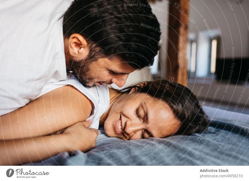 Romantic Black Couple Hugging while Sleeping in Bed Stock Photo