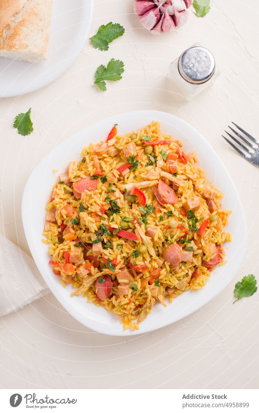 Plate with tasty Valencian rice dish meal plate serve oil garlic ceramic vegetable delicious cuisine culinary food homemade dinner kitchen meat nutrition salt