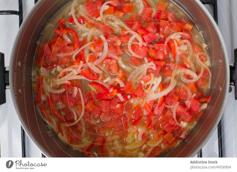 Pot with vegetable stewing on stove tomato onion pot cook food ingredient recipe process prepare meal kitchen culinary nutrition lunch cuisine hot dish