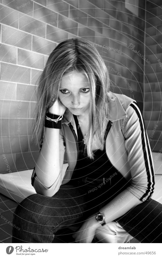 Sitting Girl Gloomy Sulk Crouch Wall (barrier) Sterile Cold Placed Portrait photograph Woman Boredom prison Prison cell Black & white photo Contrast boring set