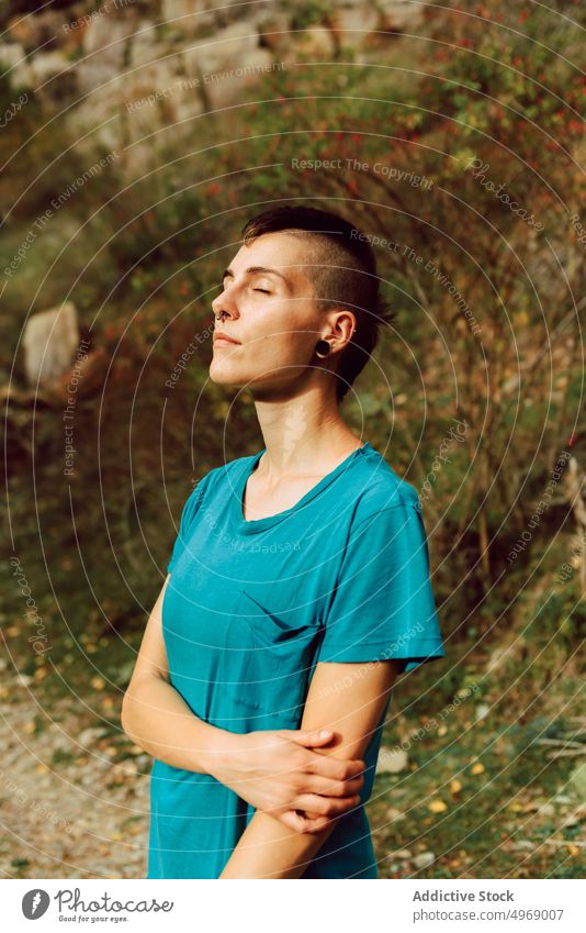 Tranquil woman breathing fresh air relaxing in autumnal forest hike break tourist calm activity travel female backpack trail destination freedom wanderlust