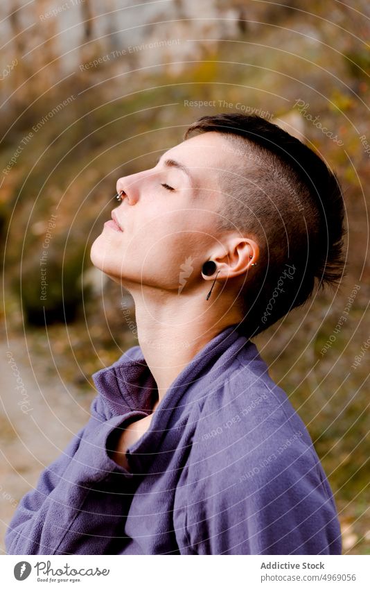 Tranquil woman breathing fresh air relaxing in autumnal forest hike break tourist calm activity travel female backpack trail destination freedom wanderlust