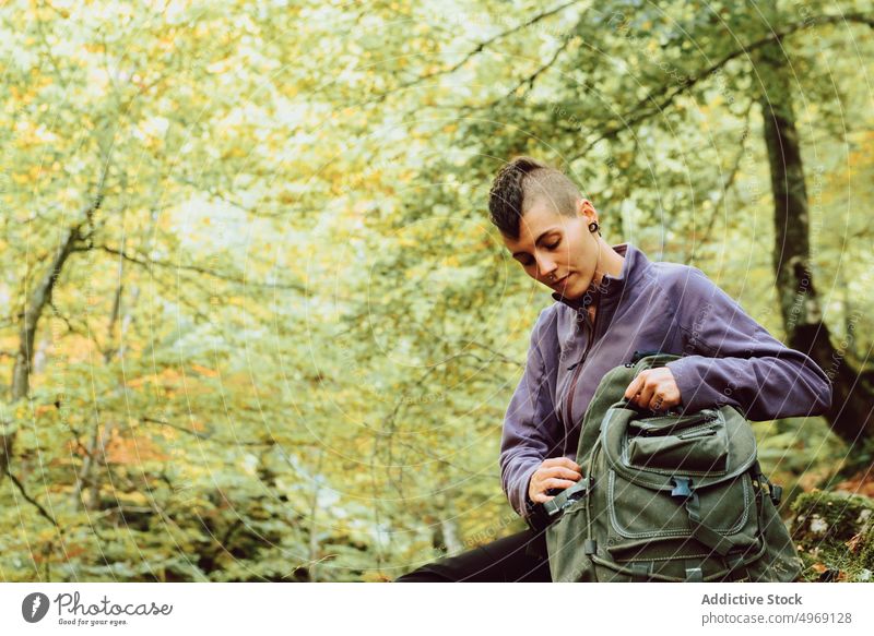 Tranquil woman breathing fresh air relaxing in autumnal forest hike break tourist calm activity travel female backpack trail destination freedom wanderlust