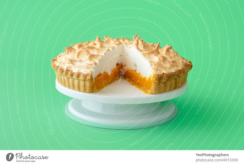 Lemon meringue cake isolated on a green background. baked bright citrus close-up color confectionary cream crust cuisine custard delicious dessert egg filling