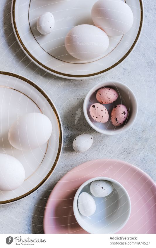 Still life of beautiful painted Easter eggs food table bowl brown colored dotted dyed easter easter egg quail eggshell chicken cute pink elegant from above