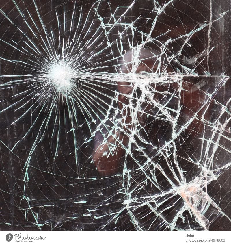 strange | cracked glass of a shop window Slice Glass Pane shattered Broken corrupted Vandalism damage Destruction Window Crack & Rip & Tear Damage