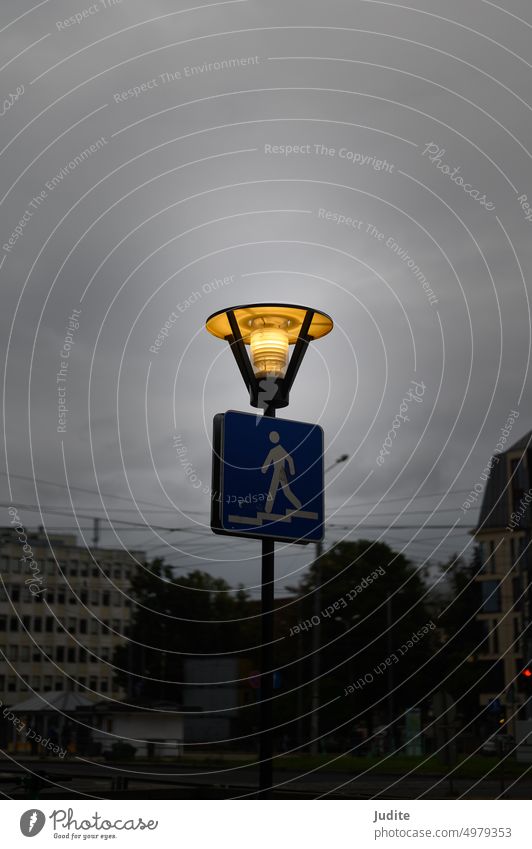 Riga, Latvia, September 11, 2022: streetlight burns to illuminate pedestrian underpass Antique Architecture atmospherically background Bad weather Blue