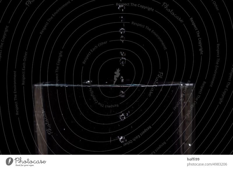 Drops fall into the water and leave traces Drops of water Water Hover Inject Surface of water Flash photo To fall Black Refraction hovering Glittering Abstract