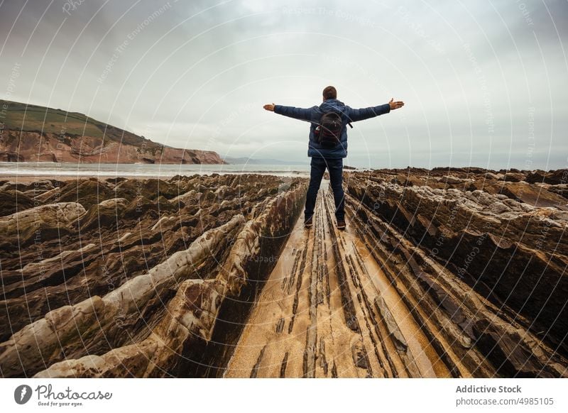 Happy man with open arms near the sea background young people person happy sky white male outdoor freedom up hands summer adult caucasian one human model