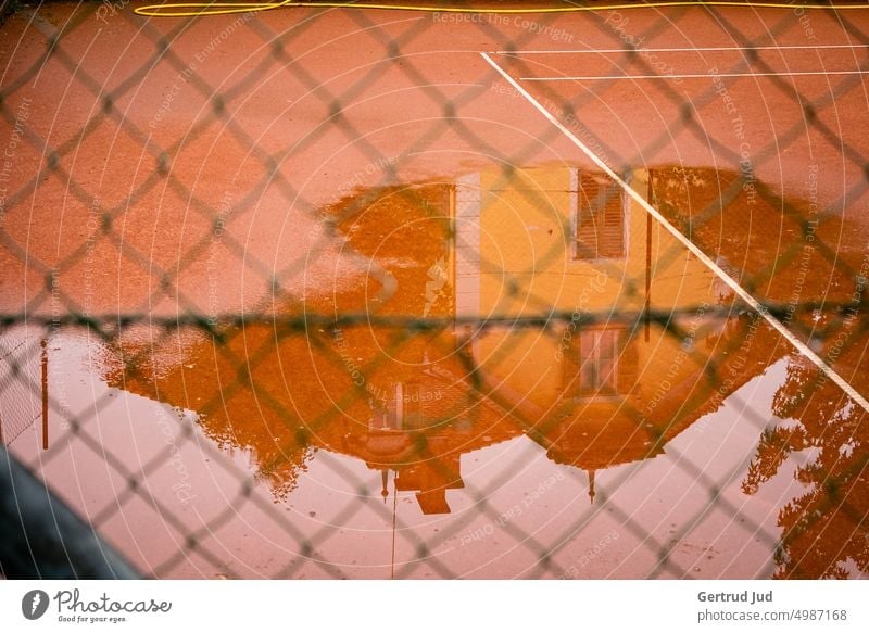 Tennis court as water level Colour orange Autumn Puddle Rainy weather reflection Reflection Water Wet Weather Bad weather Exterior shot Deserted Damp