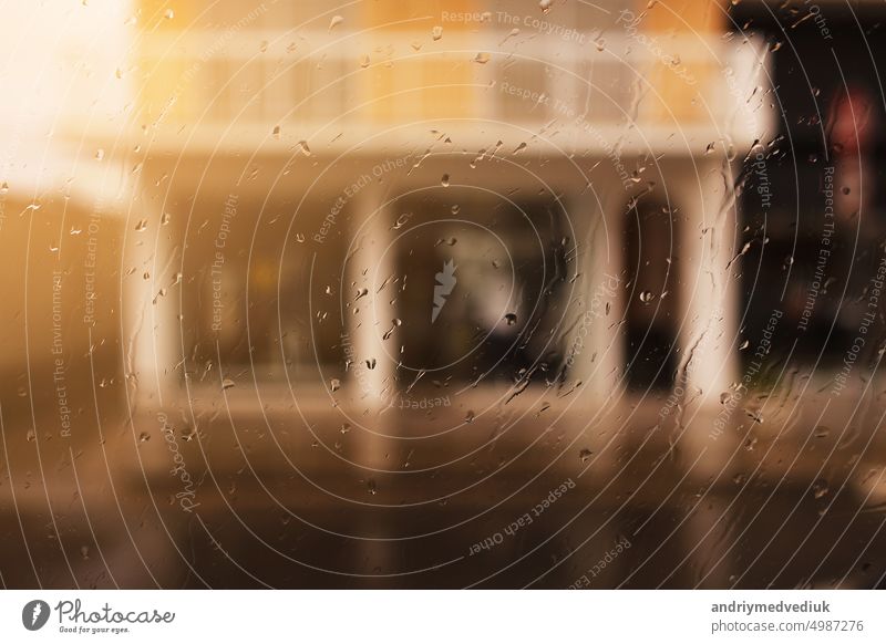 Rainy city background. Raindrops on window glass on autumn day. Wet home window with raindrops. High quality photo rainy street light storm water wet view