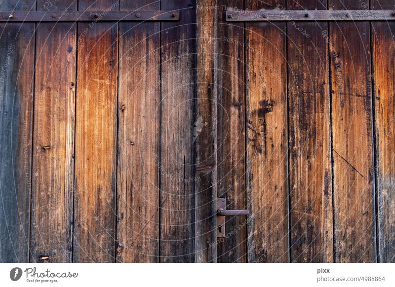 Weathered wooden gate with grain and fittings Wood Wooden door Goal Wooden gate Wood grain Metal fitting Brown Surface Structures and shapes structure Sunlight