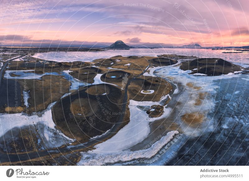 Volcanic craters near frozen lake volcanic shore snow winter sunset evening weather skutustadagigar iceland myvatn pseudocrater cold landscape season erosion