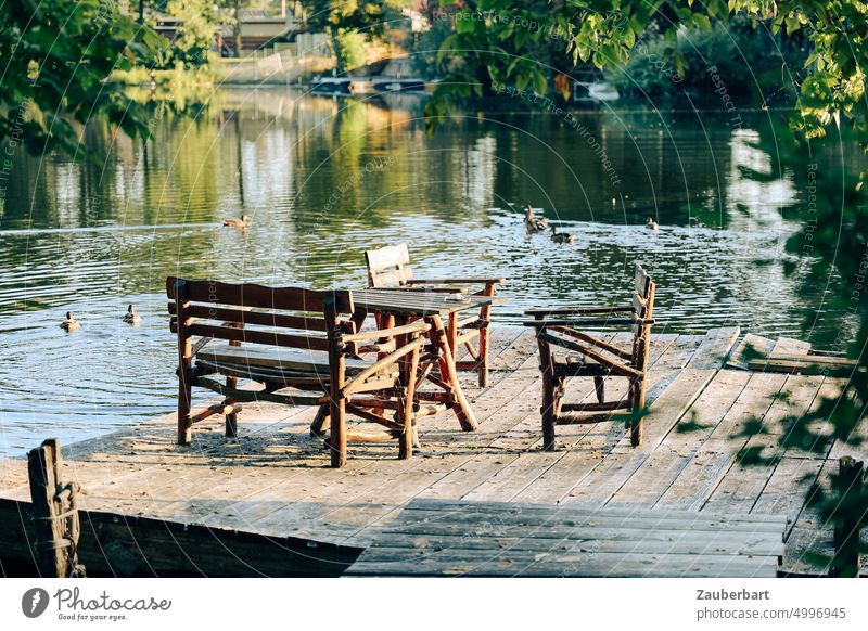 seating group of wooden garden furniture on jetty by lake, ducks behind Outdoor furniture Garden chair Wood Footbridge Lake Brandenburg Terrace Peaceful silent