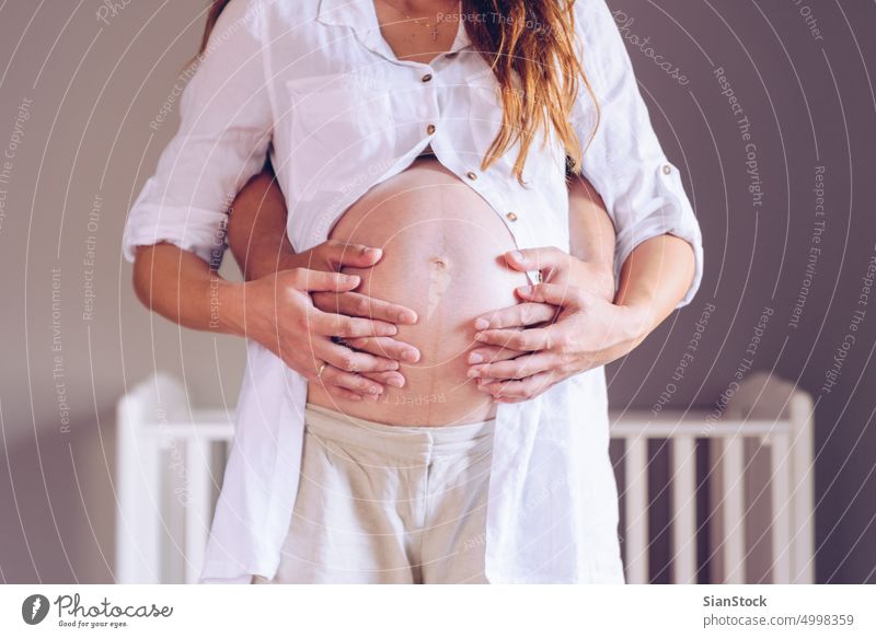 Man holding belly of his pregnant wife. son touch hands parenthood birth pregnancy new family baby people man life father woman love mother motherhood mom
