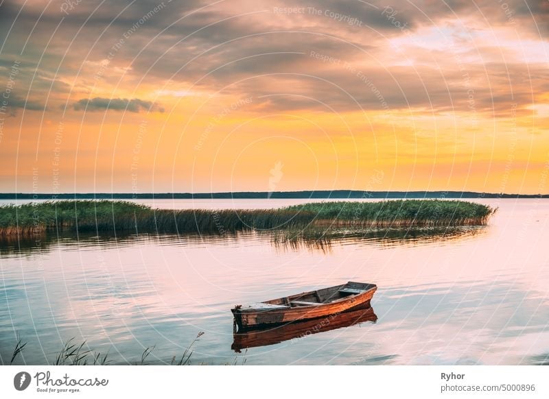 Braslaw Or Braslau, Vitebsk Voblast, Belarus. Wooden Rowing Fishing Boat In Beautiful Summer Sunset On The Dryvyaty Lake. This Is The Largest Lake Of Braslav Lakes. Typical Nature Of Belarus