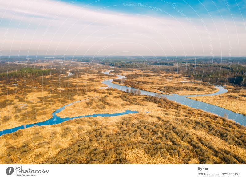 Aerial View Of Dry Grass And Partly Frozen River Landscape In Late Autumn Day. High Attitude View. Marsh Bog. Drone View. Bird's Eye View aerial aerial view