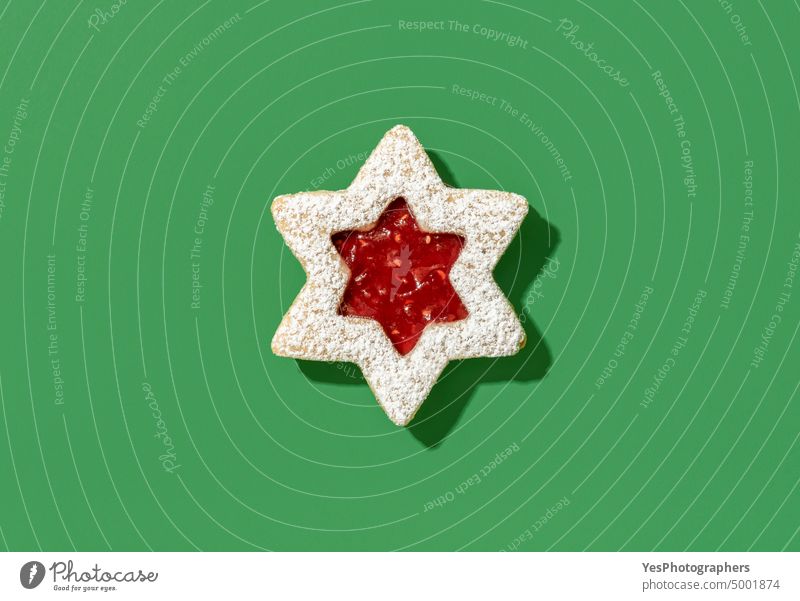 Linzer cookie with raspberry jam above view on green background austrian baked biscuit bright christmas color confectionery cookies cuisine december decoration