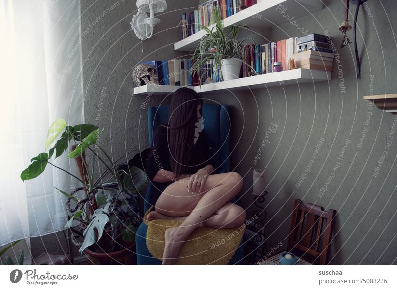 woman sitting at home under a bookshelf Woman Legs hair Flat (apartment) Living room Bookshelf Houseplant Wall (building) Window