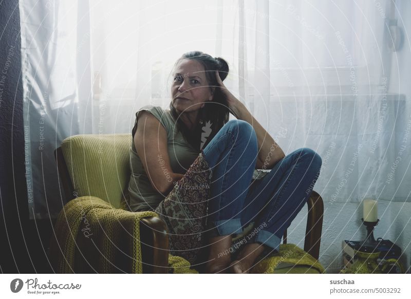 woman on armchair in front of a window Woman Meditative Sit Flat (apartment) Adults Think Loneliness portrait Sadness Feminine Depression