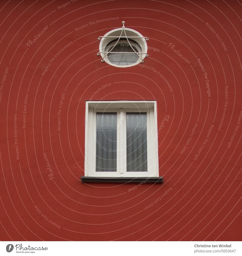 Detail of red plastered house with one round and one square window Window Facade red facade Ventilate Tilted window Rendered facade Window pane Window frame