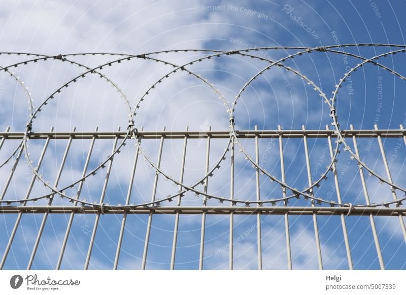 No entry - high metal fence with barbed wire in front of blue sky with clouds Fence Metalware Wire Barbed wire Backup no access Border Barrier Safety Bans