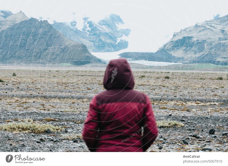 Cinematic Rear View Of Woman Looking At Glaciers .Freedom liberty and scape concept.Natural wild view.Adventure vacations healthy lifestyle backpacking glacier