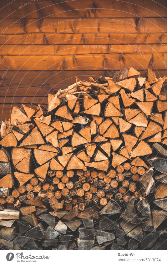 a stack of firewood in front of a wall Firewood Heat Winter wood supply Winter stock Stack of wood chill Supply Wood
