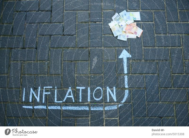 Inflation - arrow points to money inflation Money Bank note Arrow Chalk concept Euro loss in value finance Luxury Save