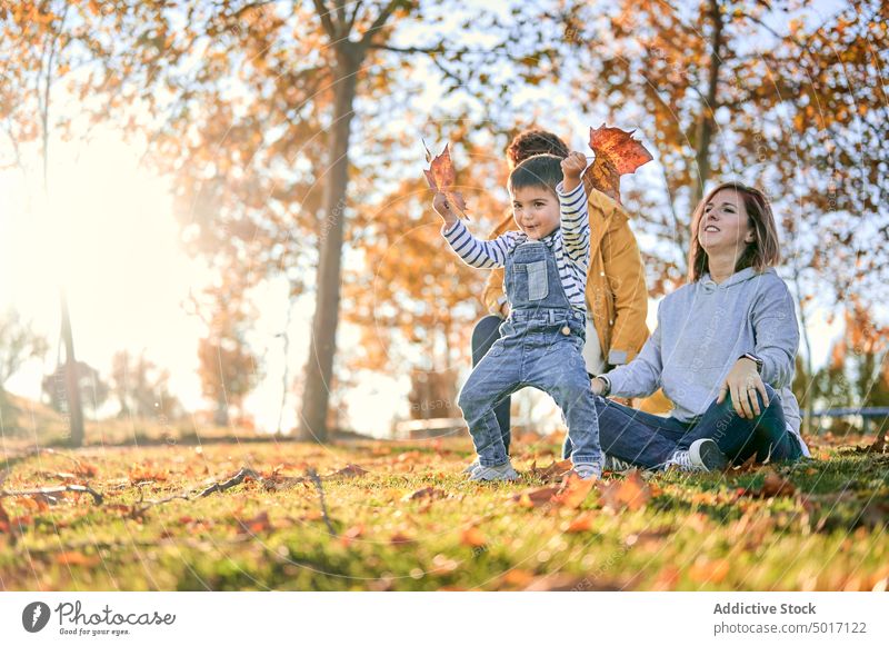 Lesbian family with son in autumn park lesbian child play couple together lgbt having fun love relationship childhood boy kid bonding mother smile joy women