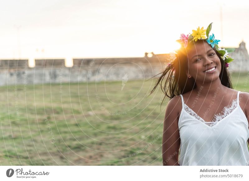 Charming ethnic woman in flower wreath in summer floral charming tender colorful smile natural female bloom fresh blossom nature content romantic feminine