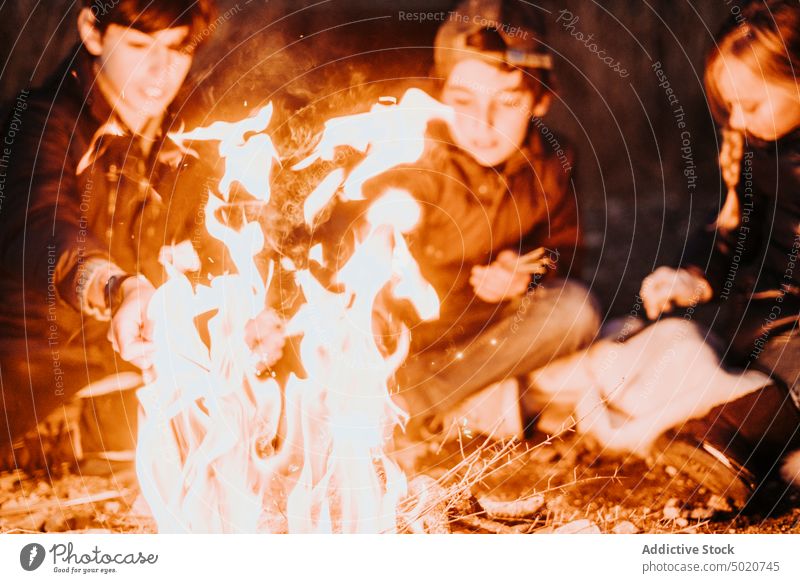 Group of young friends camping and burning a wood fire - a Royalty Free  Stock Photo from Photocase