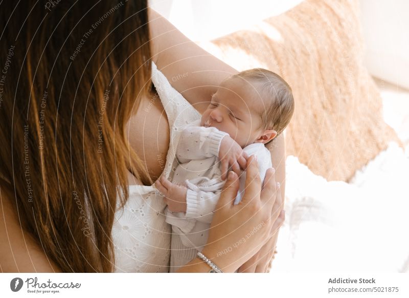 Mother carrying baby in arms mother hug sleep love childcare tender calm affection woman press chest together embrace gentle eyes closed touch relax delicate