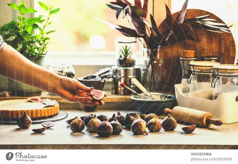 https://www.photocase.com/photos/5026049-women-hand-holding-figs-on-kitchen-table-with-baking-tools-at-window-background-lifestyle-photocase-stock-photo-large.jpeg