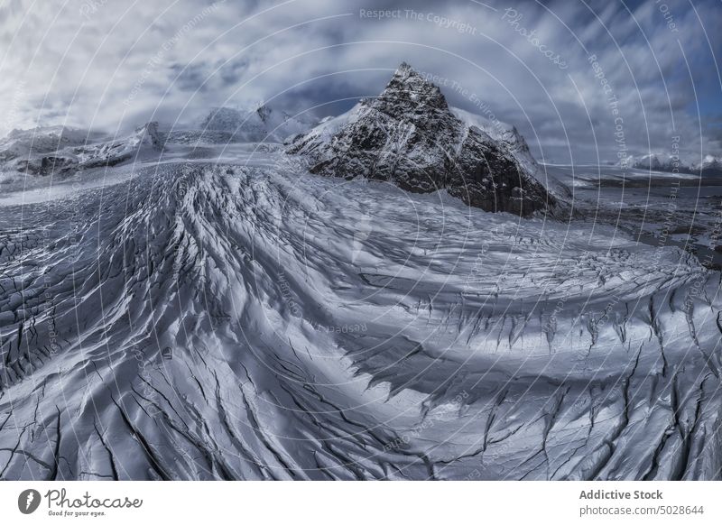 Snowy rocky mountains on winter day snow landscape scenery glacier range nature ridge fjallsarlon vatnajokull iceland breathtaking cloudy frozen highland