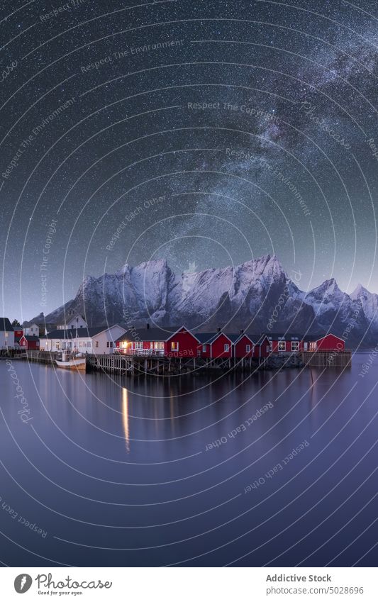 Starry sky above mountainous village near lake milky way highland house night lofoten islands norway star starry reflection spectacular picturesque vivid scenic