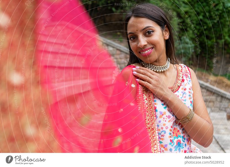 Dreamy ethnic woman in traditional wear smile dress style sari indian thoughtful stair happy step outfit female ancient indigenous authentic grace young culture