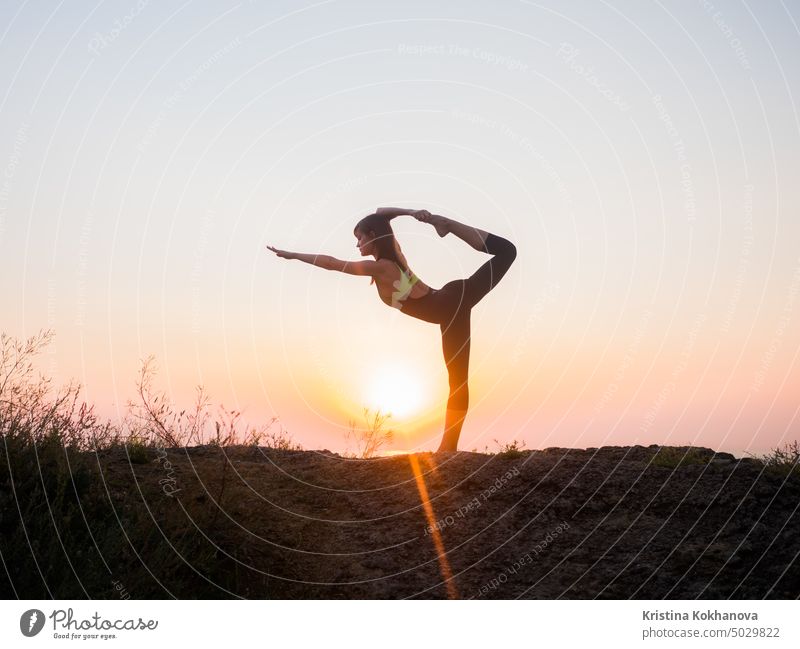 Women doing yoga outdoors at sunrise. Morning meditation Stock Photo by  leikapro