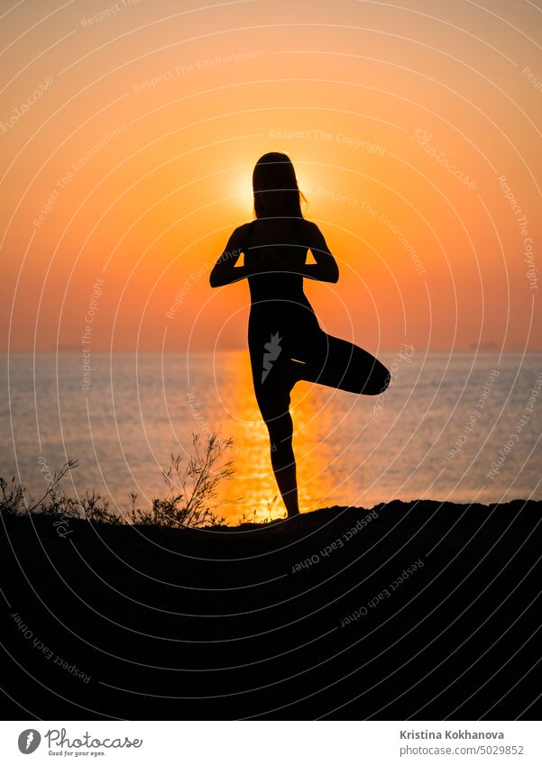 Woman with closed eyes doing yoga asana meditation on the beach. Female in  sport clothes sitting in lotus pose on mat at sunset stock photo (259943) -  YouWorkForThem