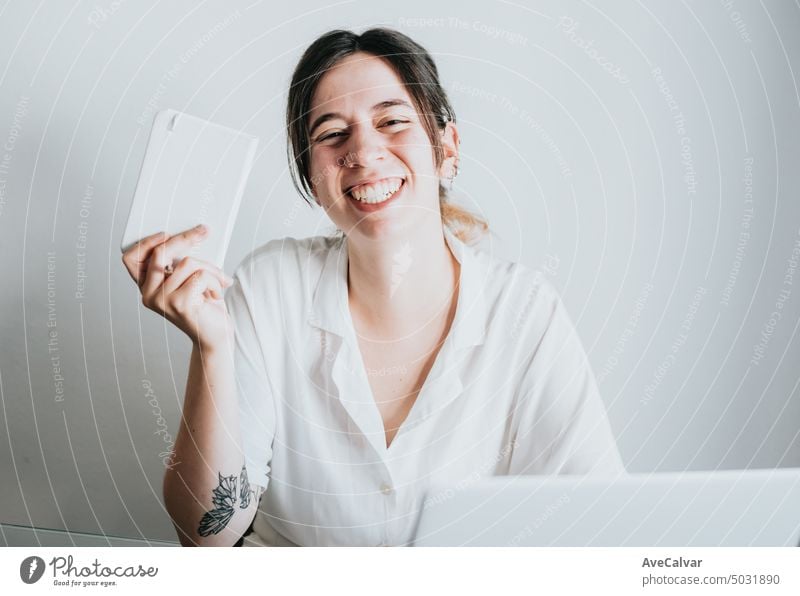 Young and smiling business woman working with laptop while taking notes, portrait image copy space person office cheerful smart smile workplace caucasian female
