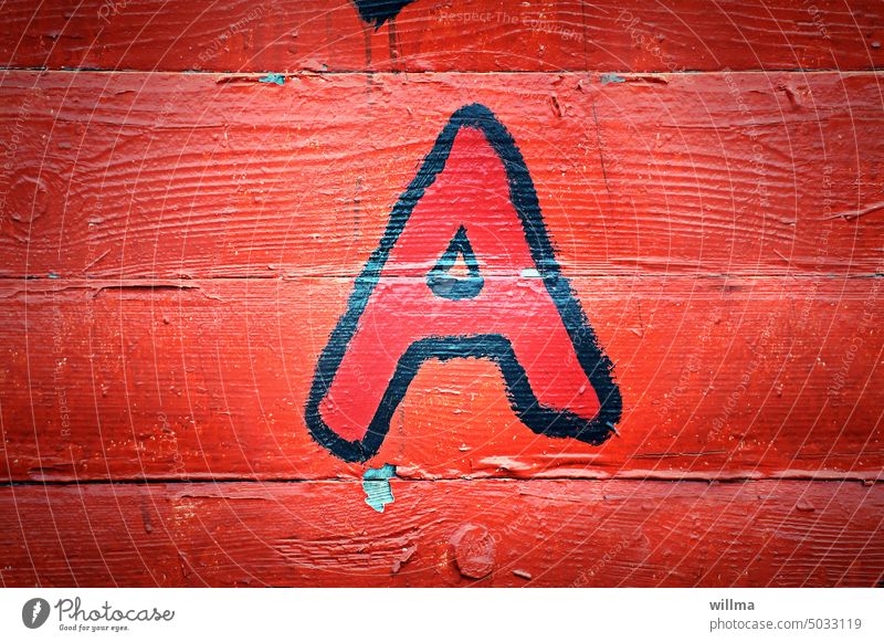The letter A on red board wall Characters Red Graffiti painted on Wooden wall Beginner