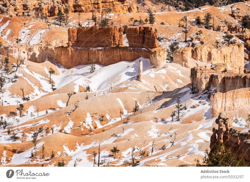 Rocky formations in mountainous terrain snow landscape rocky picturesque hoodoo bryce canyon national park nature winter desert natural tourism geology